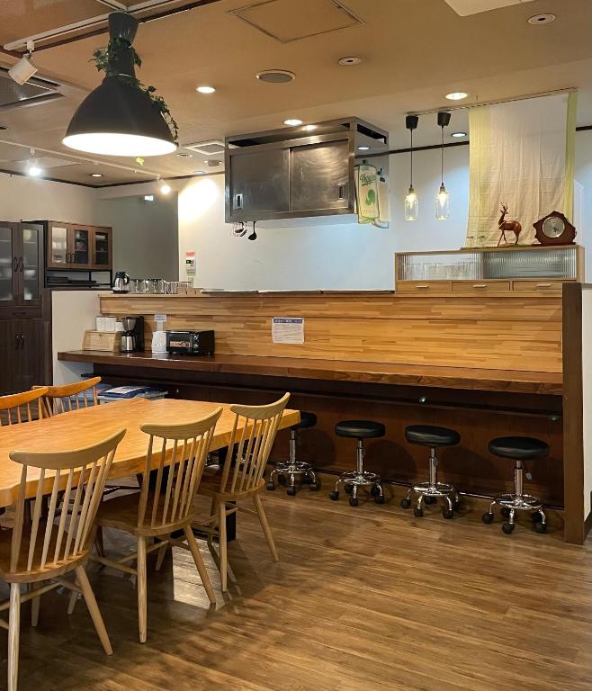 una cucina con tavolo, sedie e bancone di Nara Guesthouse 3F a Nara