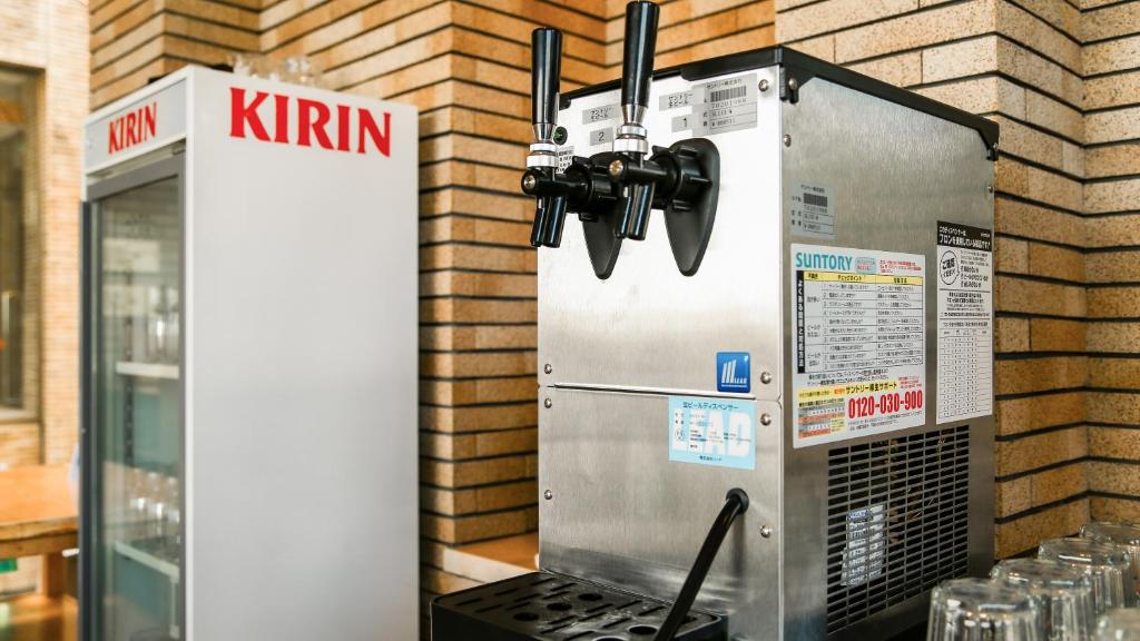a machine that is next to a brick wall at 熱海山荘 in Atami