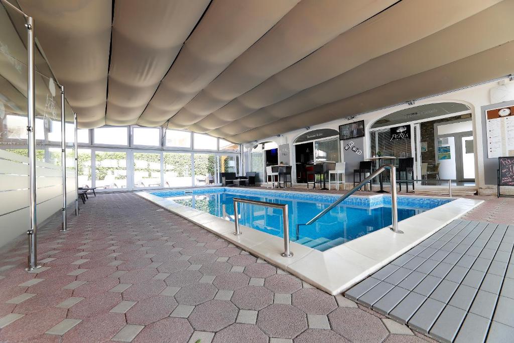 a large swimming pool in a building at Ratko Peris in Novalja