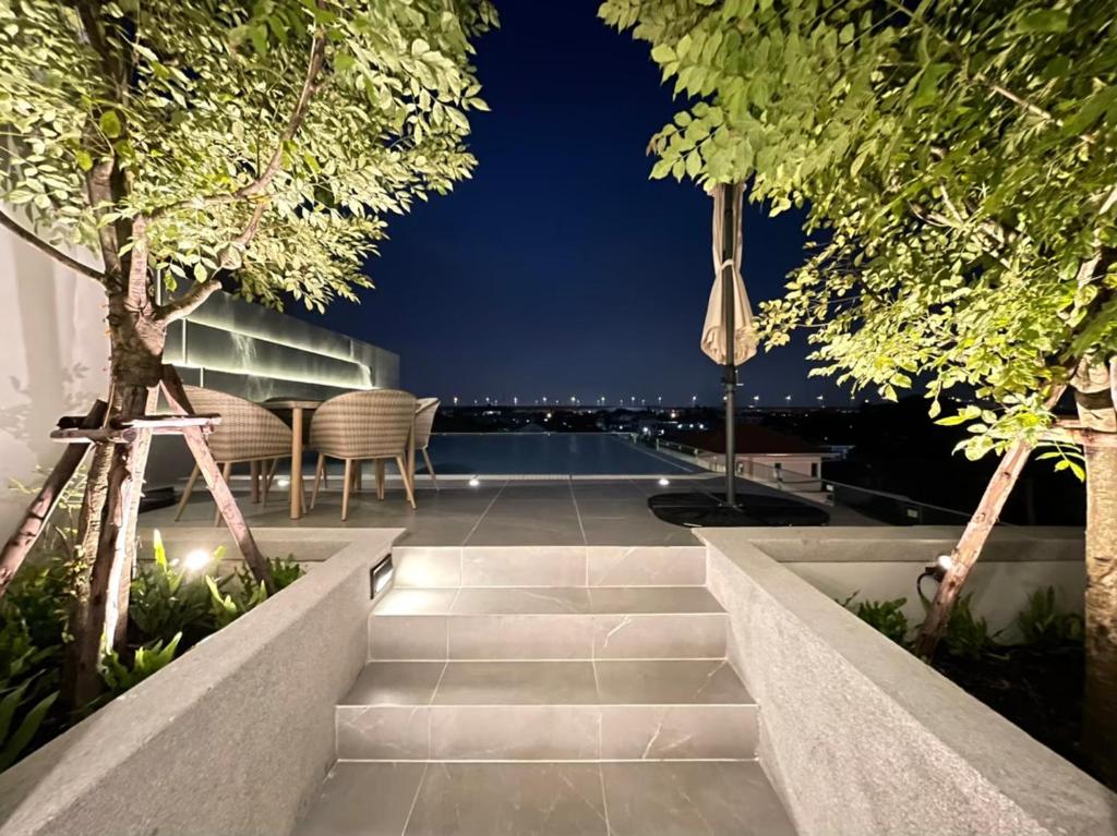 a patio with a view of the city at night at The Pearl Residence House-At least 2 months in Bang O