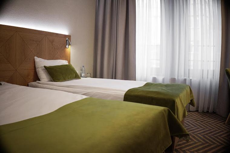 Posteľ alebo postele v izbe v ubytovaní Hotel Impresja