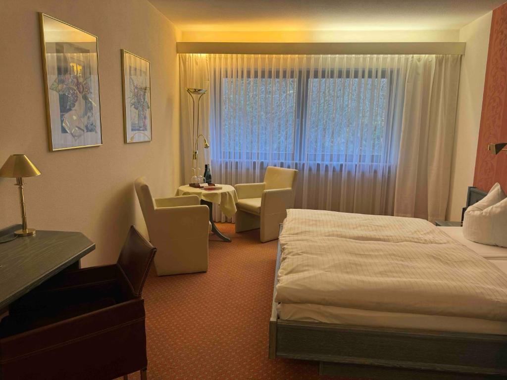 Postel nebo postele na pokoji v ubytování Hotel Das Waldhaus in Maikammer