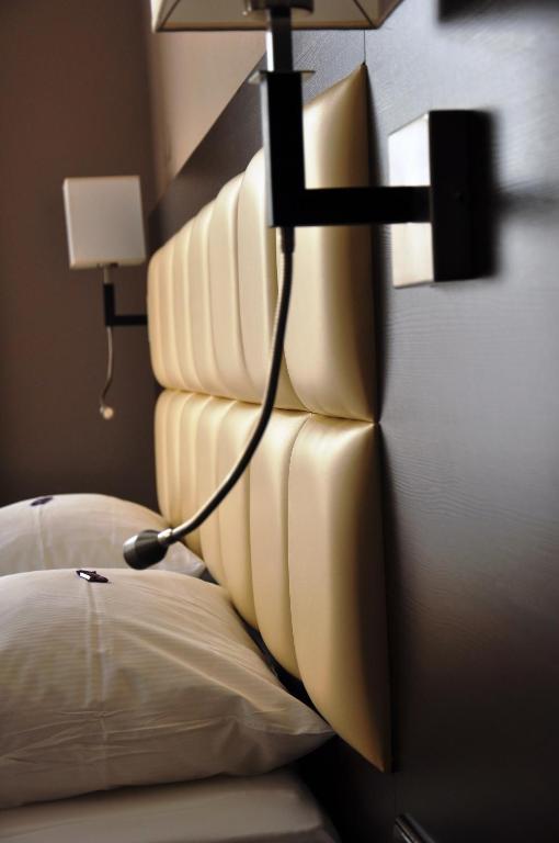 Postel nebo postele na pokoji v ubytování Hotel Minerva