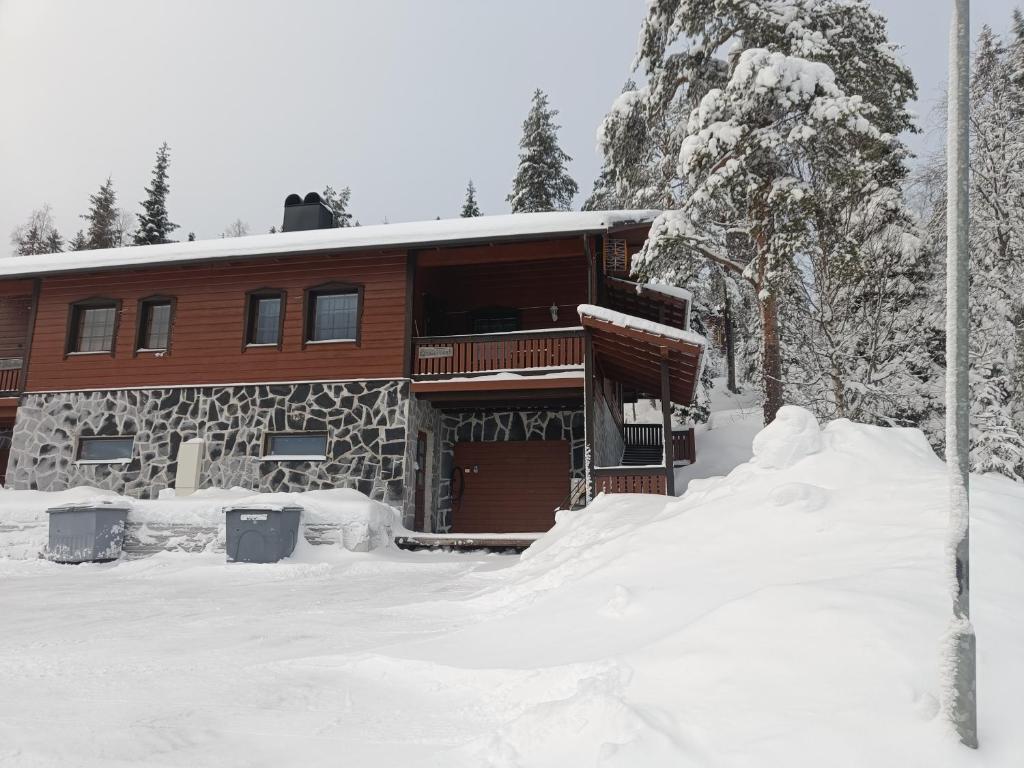 a log cabin in the snow with snow around it at Kärpänrinne B in Syöte