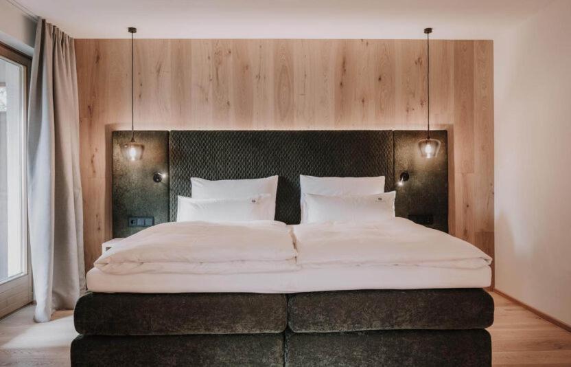 Postel nebo postele na pokoji v ubytování Hotel Oberforsthof