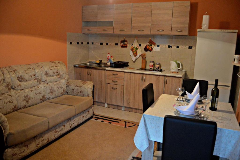 a living room with a couch and a table and a kitchen at Apartments Bućin in Kotor