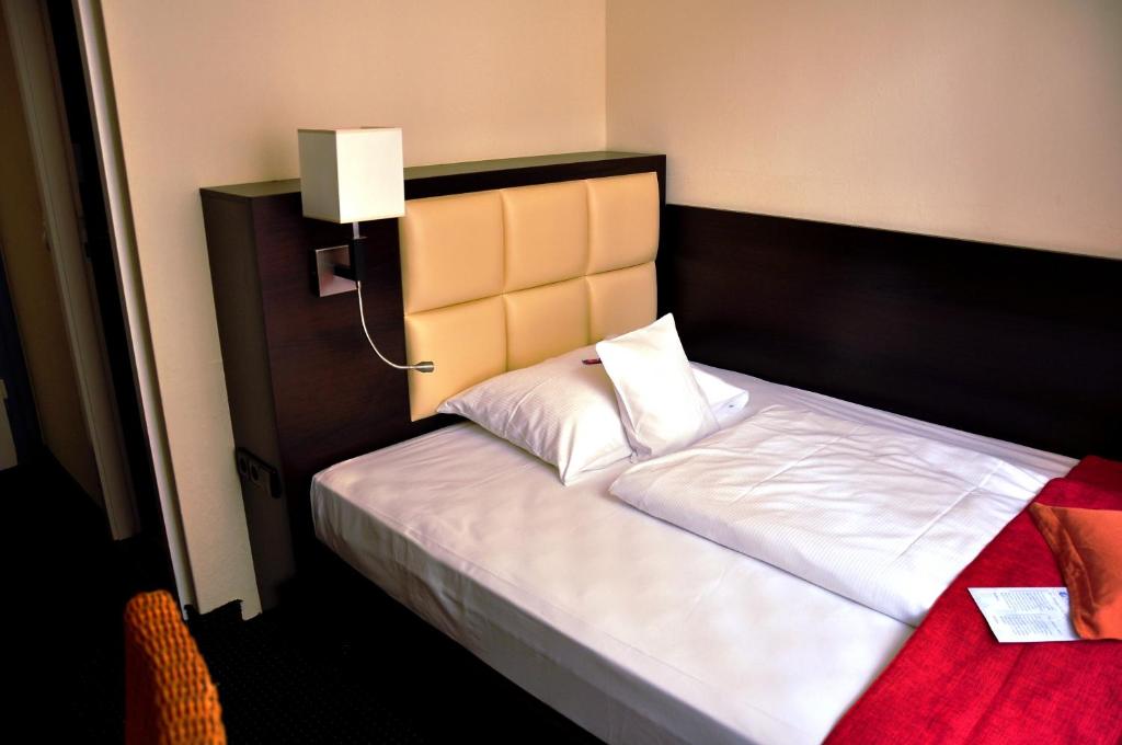 Postel nebo postele na pokoji v ubytování Hotel Minerva