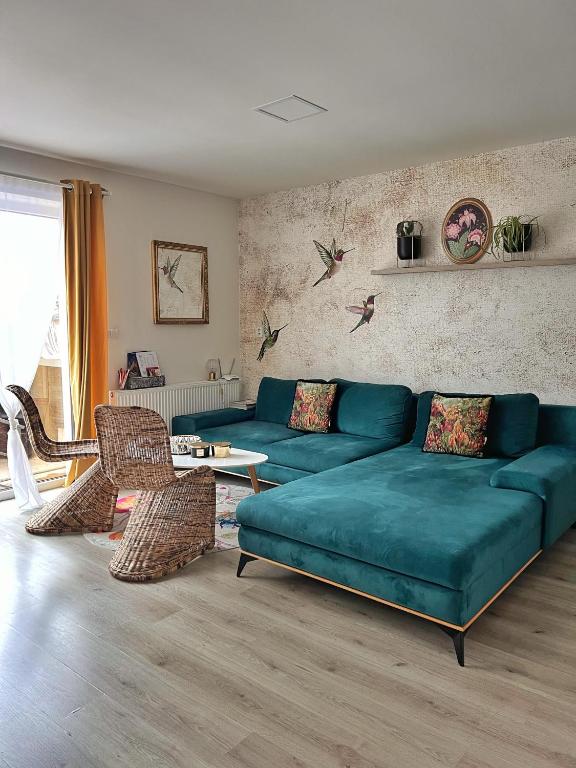 a living room with a blue couch and chairs at Ubytování Hrušky in Hrušky