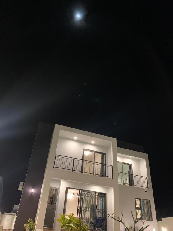 a building with a balcony with the moon in the sky at LuxNar Beach GF in La Gaulette