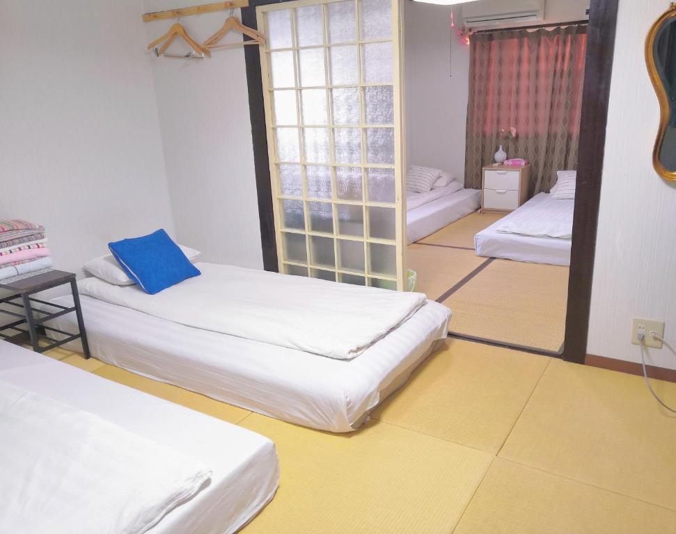 Säng eller sängar i ett rum på Nippori Osaka Nishi-Tengachaya Guesthouse西天下茶屋アパートメント