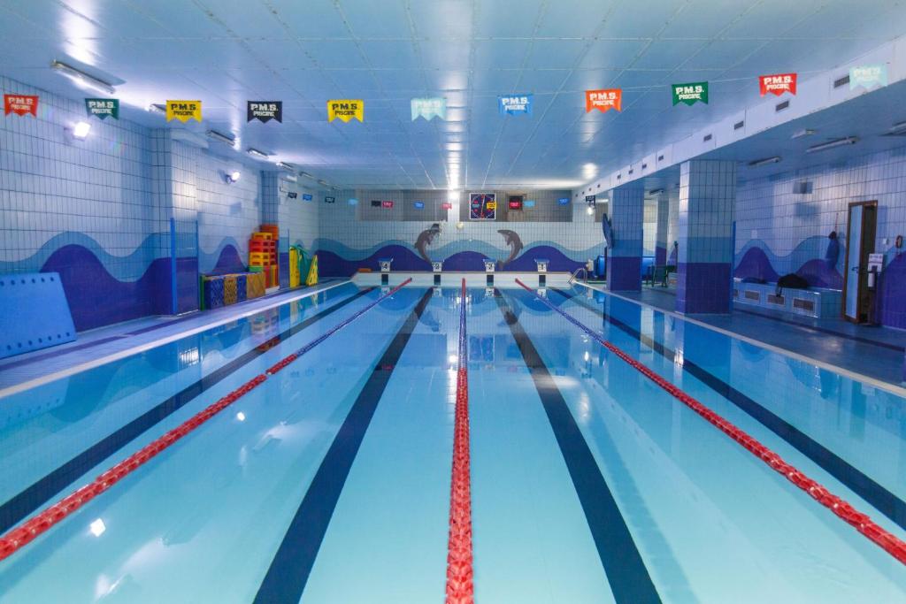 a large swimming pool with lanes in a gym at Suite Malu in Naples