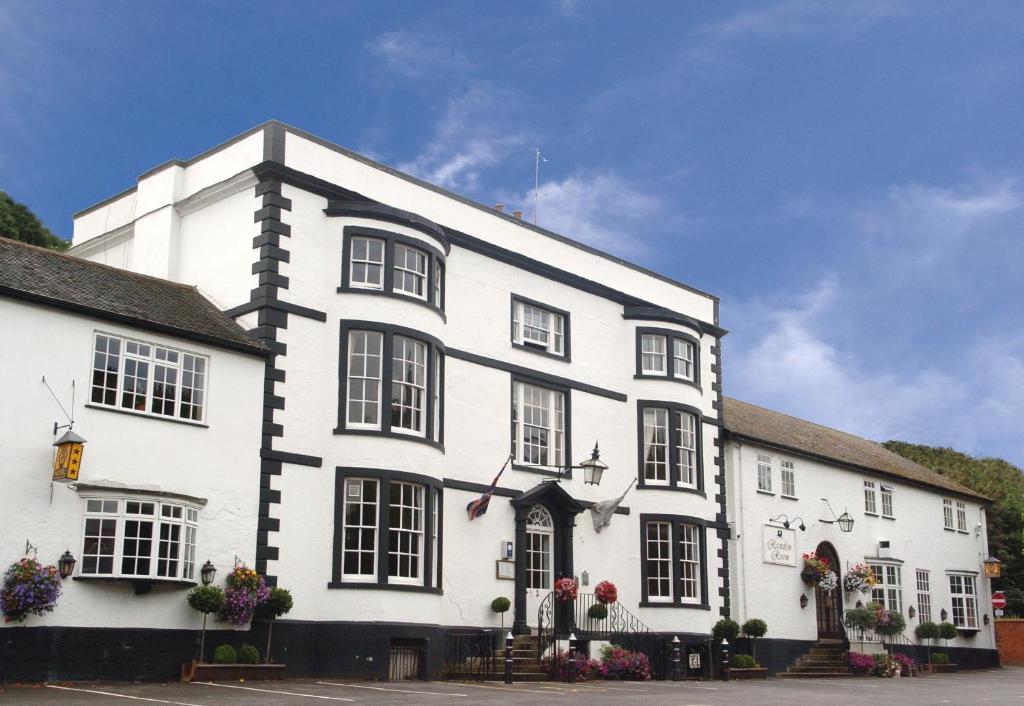 a large white building with a large window at Donington Manor Hotel in Castle Donington