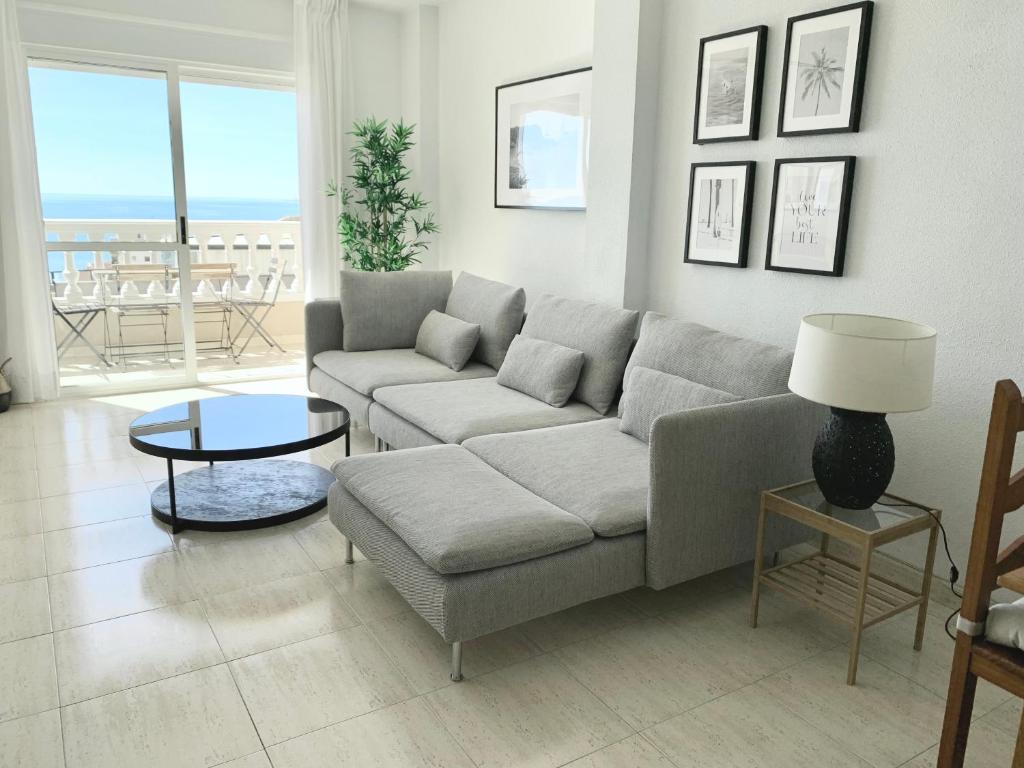 a living room with a couch and a table at Panoramic Sea Views with Balcony, Air Conditioning and Parking in Aguadulce