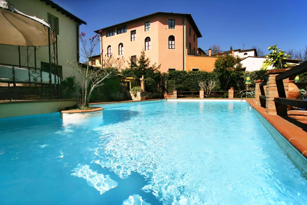 a swimming pool with a large swimming pool in the middle of it at Albergo Del Chianti in Greve in Chianti