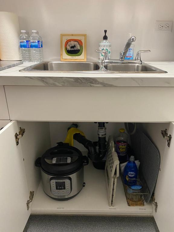 a kitchen cabinet with a sink and a counter top at Our Place Up North BnB in Huntsville