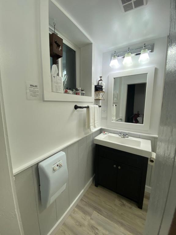 a white bathroom with a sink and a mirror at Our Place Up North BnB in Huntsville