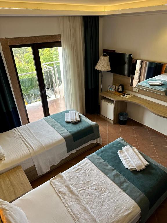 Postel nebo postele na pokoji v ubytování The Kumsal Hotel Oludeniz
