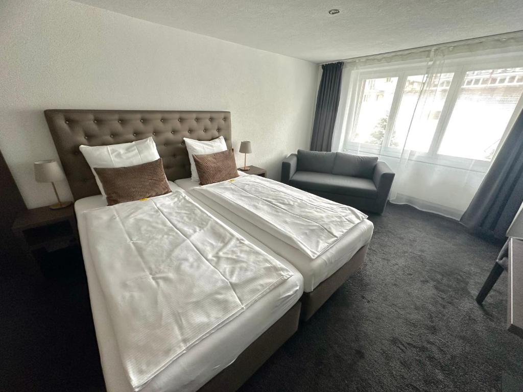 Postel nebo postele na pokoji v ubytování Hotel Baslertor