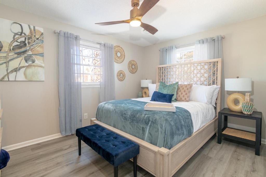 a bedroom with a bed and a ceiling fan at Family friendly & 5-mins to downtown Graham in Graham