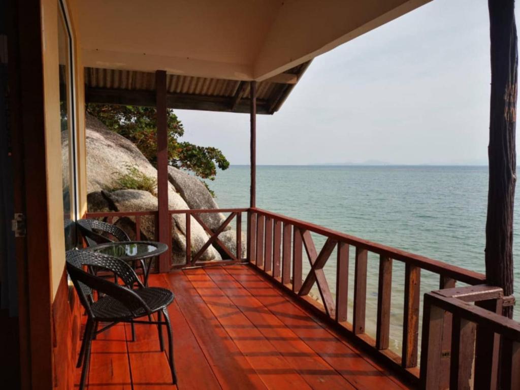 a balcony of a house with a view of the ocean at Golden Beach Resort Koh Phangan in Ban Tai