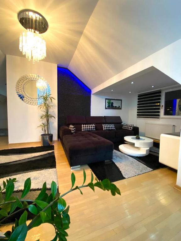 a living room with a couch and a table at Luxury Studio Black & White in Sarajevo