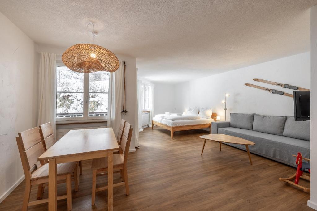 a living room with a couch and a table at 2302 Charmante 2,5-Zimmer-Wohnung mit Suedbalkon und stilvoller Einrichtung in Vulpera