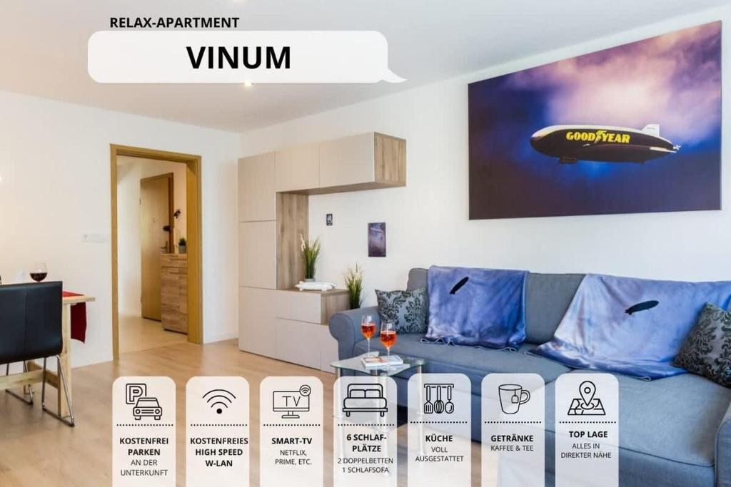 a living room with a blue couch and a tv at Ferienwohnung EDEN Apartment´s Vinum in Friedrichshafen