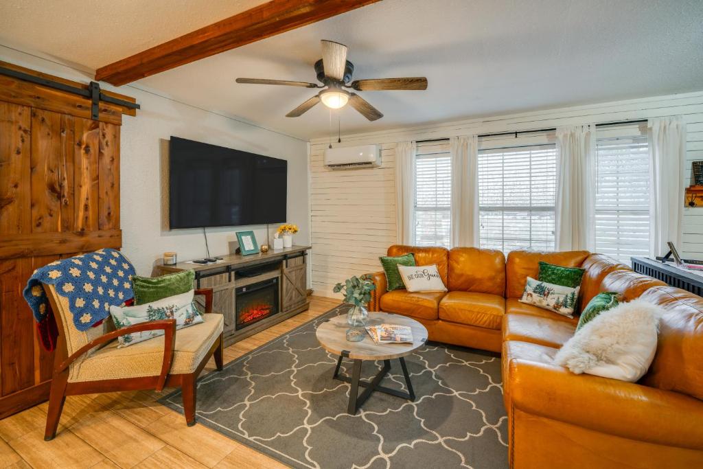 a living room with a couch and a flat screen tv at RockinB88 Ranch Retreat Terrell Home Near Shops in Terrell