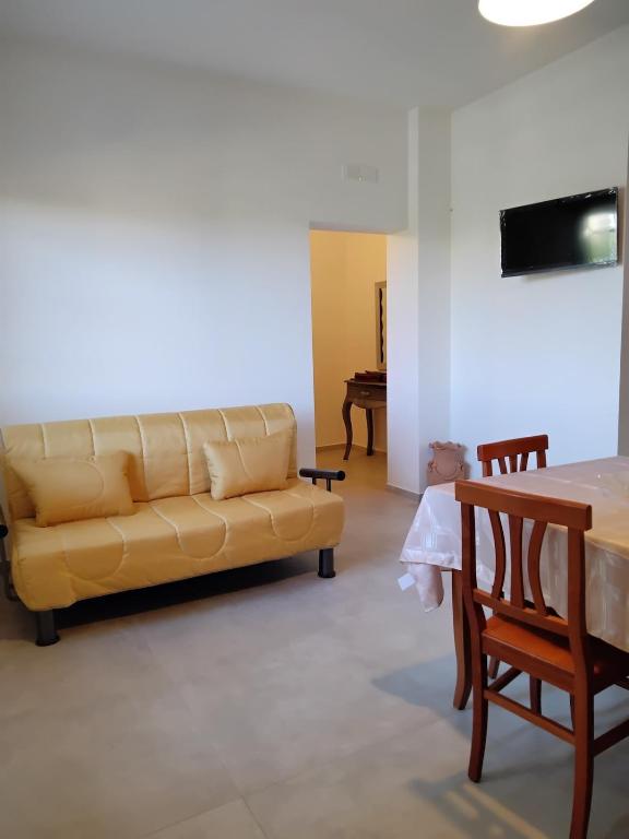 a living room with a couch and a table at Casa Acqua Marina in Bisceglie