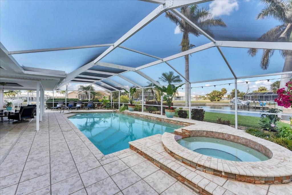 a large swimming pool with a glass roof at 803 Napoli in Punta Gorda