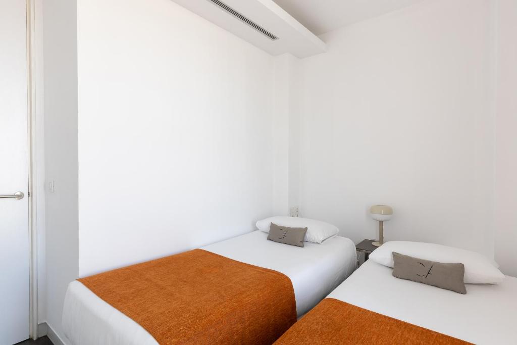 Posteľ alebo postele v izbe v ubytovaní Cosmo Apartments Sants