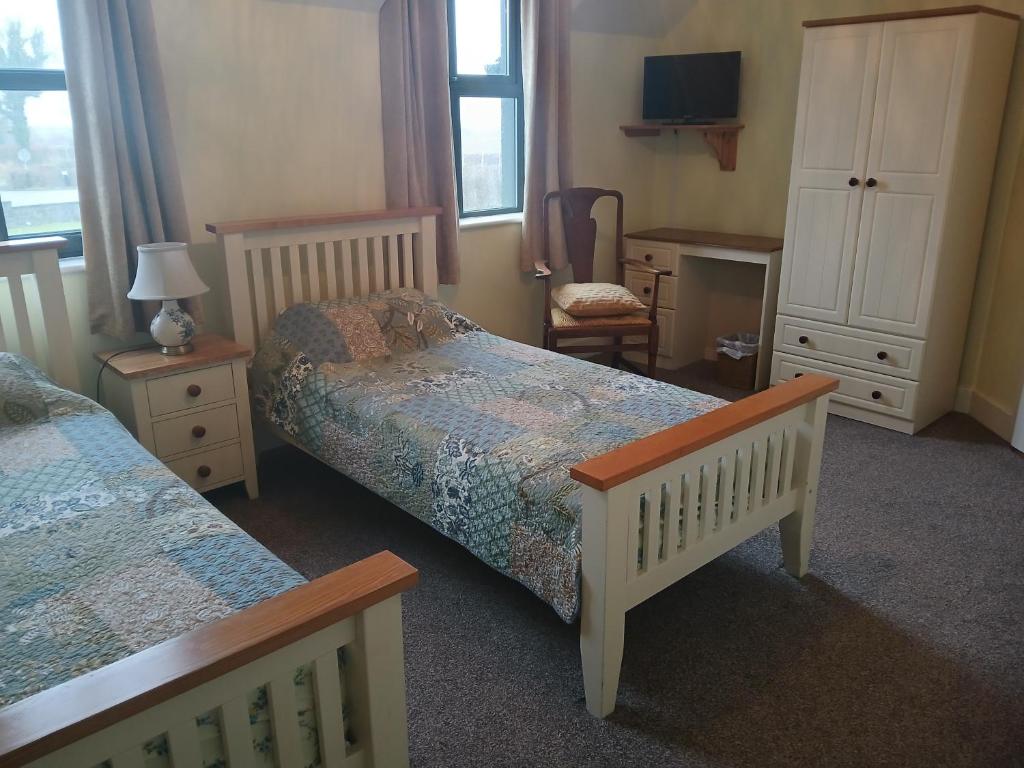 Postel nebo postele na pokoji v ubytování Killooley Lodge