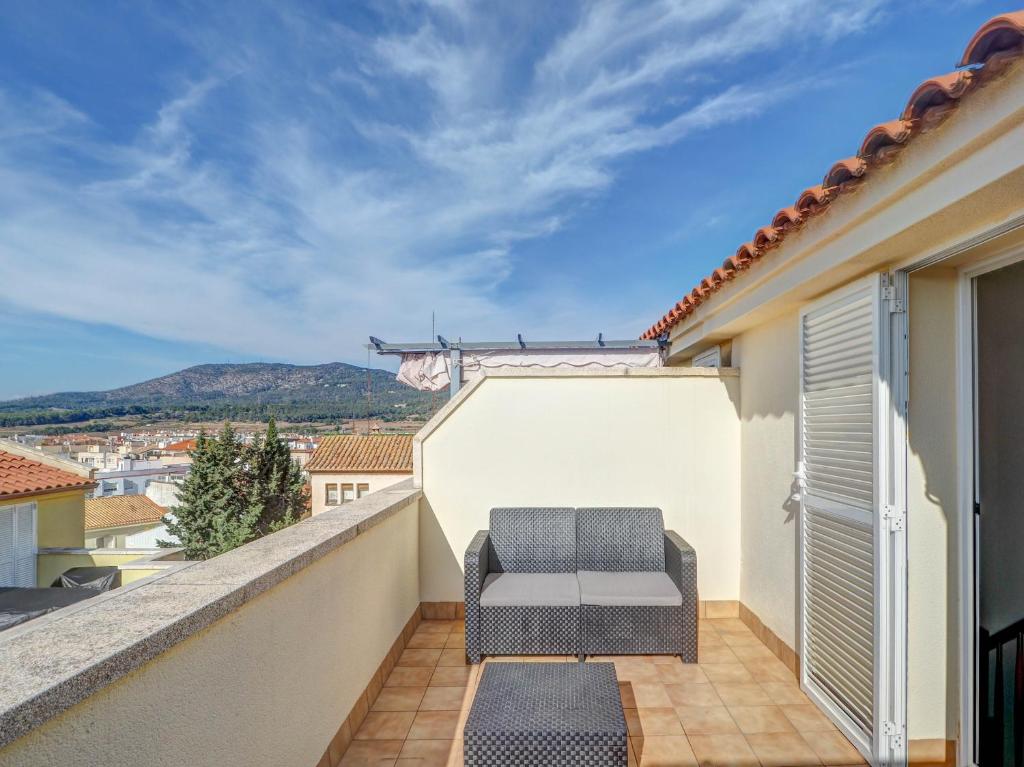 a balcony with a couch and a view at Ribes Duplex by Hello Homes Sitges in Sitges