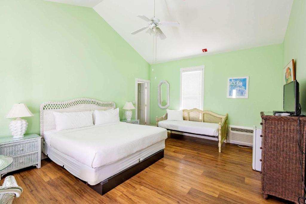une chambre avec un lit blanc et une télévision dans l'établissement Deluxe King - Curry Mansion with Pool!, à Key West