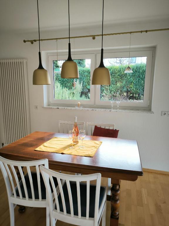 a dining room table with two wine glasses on it at Weinbergblick in Kirchheim am Neckar
