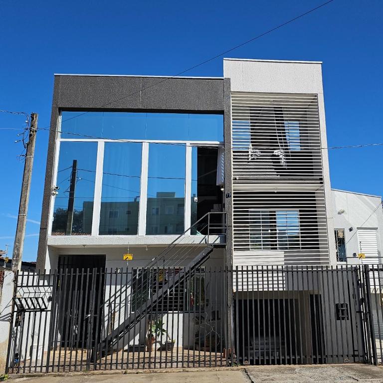 a house with a fence in front of it at Casa Central Super Conforto 78 in Ponta Grossa