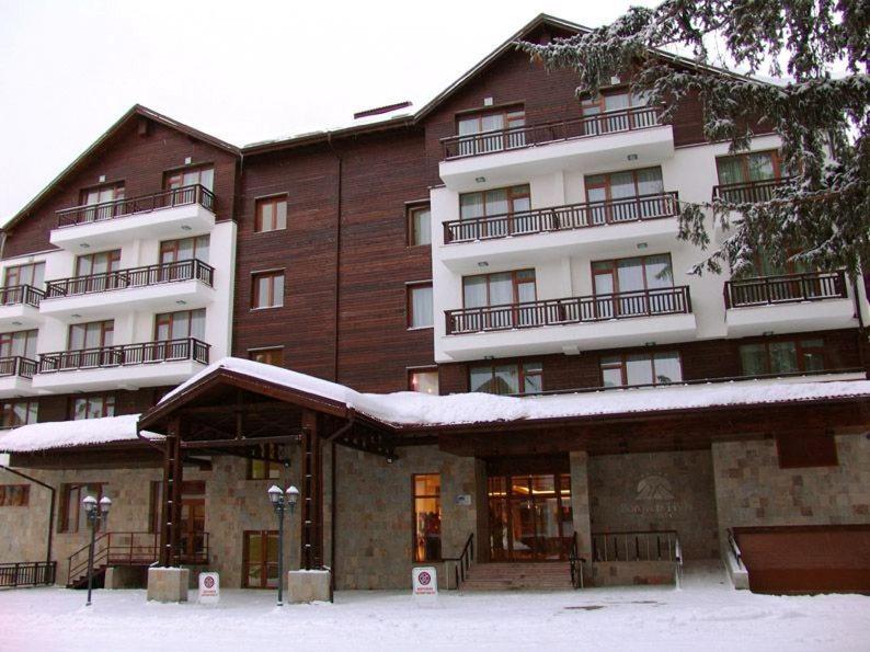 a large building with snow on top of it at Borovets Hills Ski & Spa - Half Board in Borovets