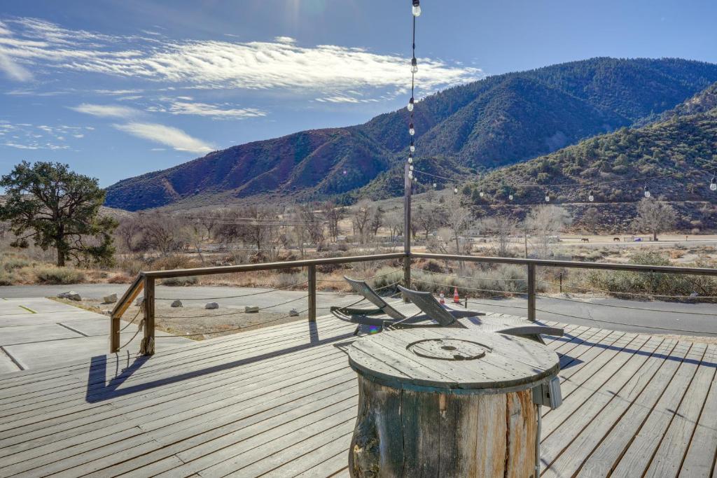 a deck with a table and chairs on a mountain at Private Deck & Views: Frazier Mountain Cabin in Frazier Park