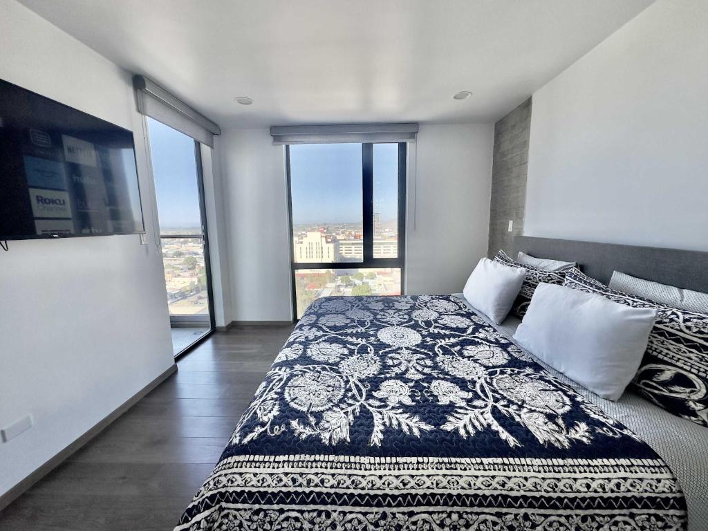 a bedroom with a bed and a large window at Tijuana Condo at Avenida Revolución 9th floor in Tijuana