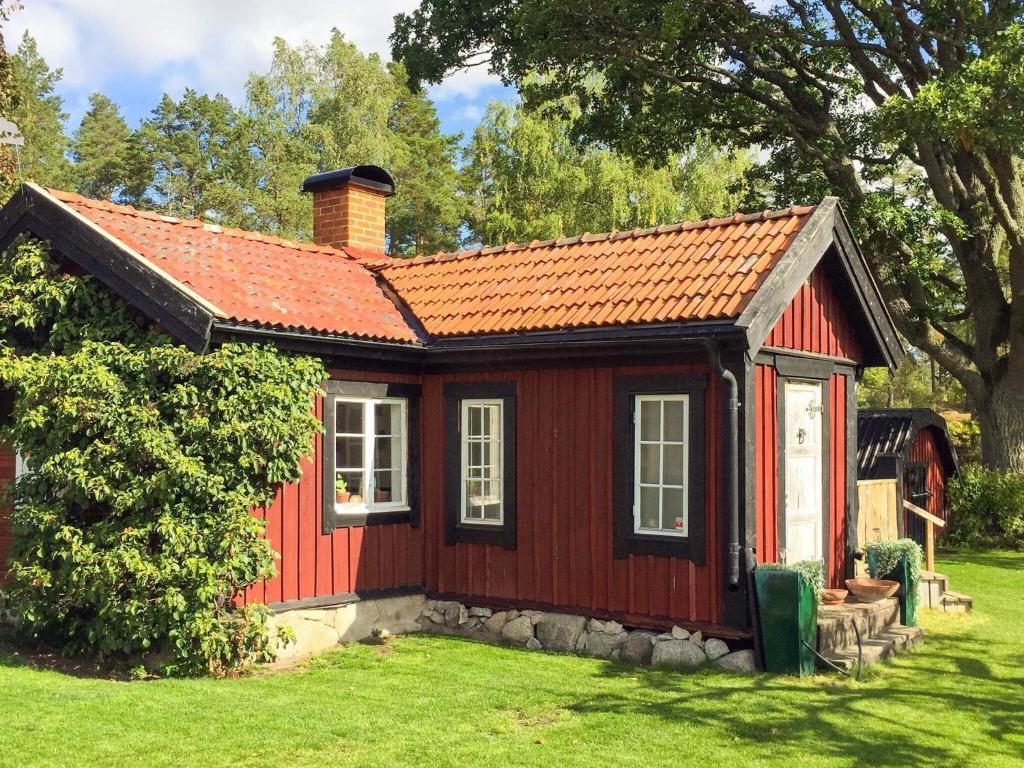 a red house with a red roof at 4 star holiday home in Märsta in Märsta