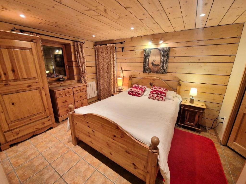 a bedroom with a bed in a room with wooden walls at Chalet Rianne - Beau chalet 8/10 personnes MAE-9554 in Modane