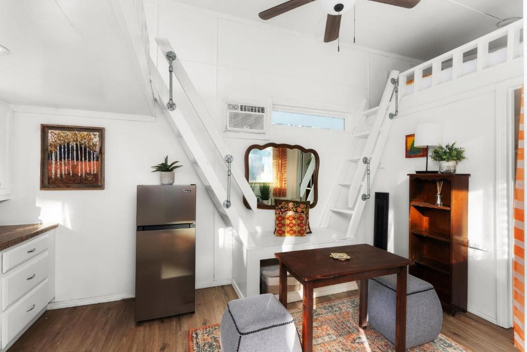 a kitchen with a refrigerator and a table at Cozy Tiny Home on an Eco Farm in Austin