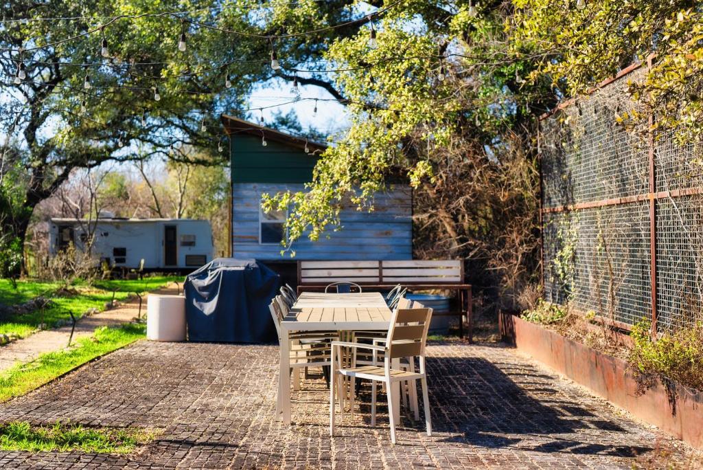 a table and chairs sitting on a brick patio at Cozy Tiny Home on an Eco Farm in Austin