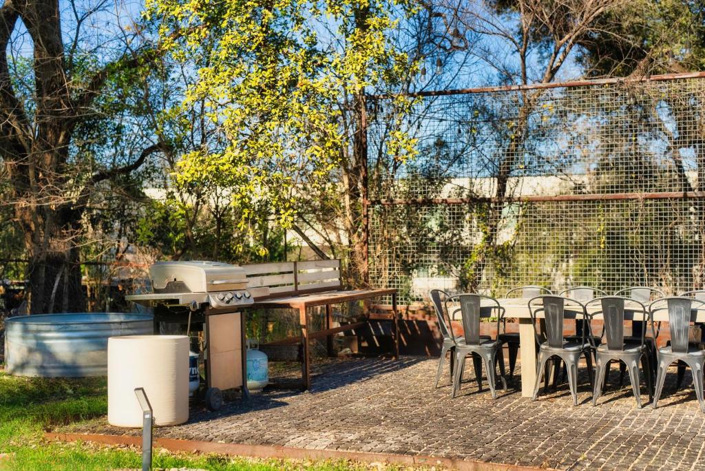 a picnic table and chairs and a piano in a yard at Cozy Tiny Home on an Eco Farm in Austin