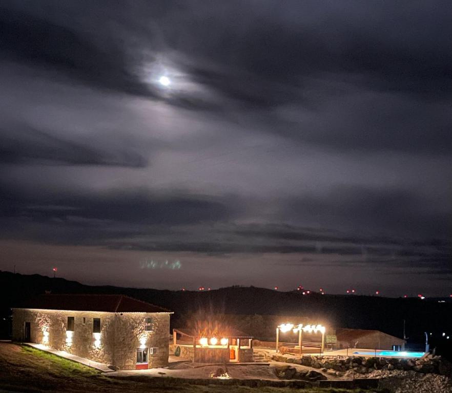 a night view of a building with the moon in the sky at Solar do Prazo-Serra & Charme in Gonçalo