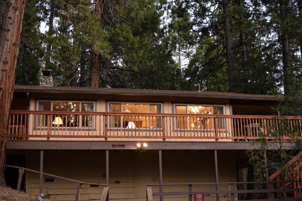 a tree house with a wrap around deck at Sequoia House at The Redwoods in Wawona