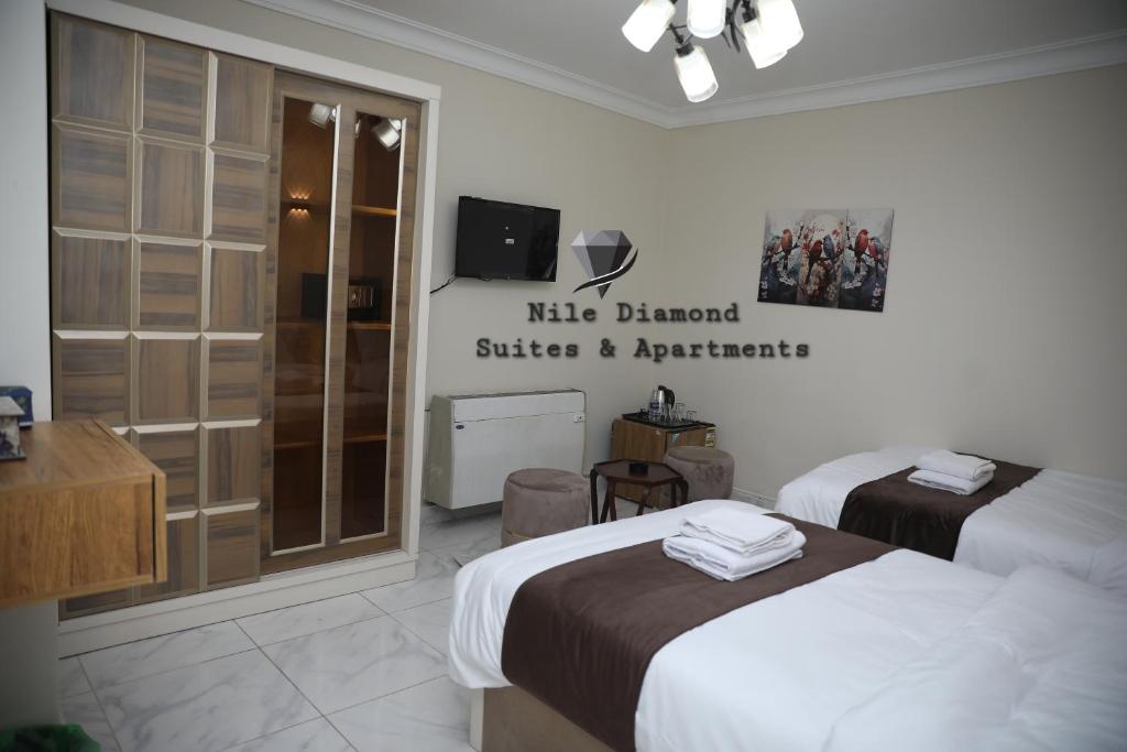Postel nebo postele na pokoji v ubytování Nile Diamond Suites