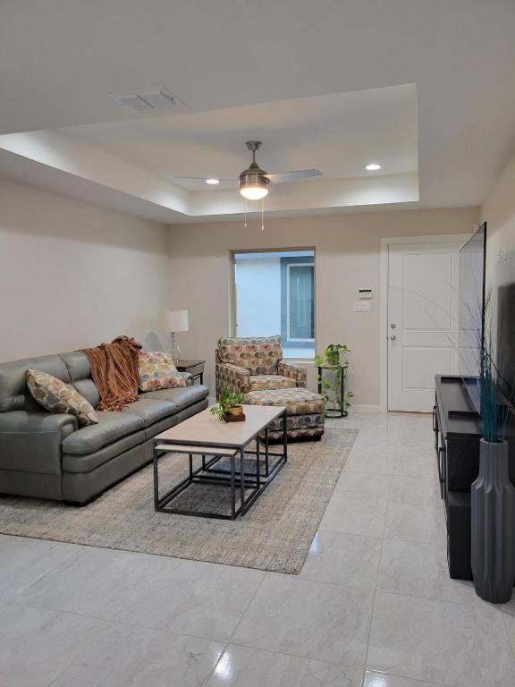 a living room with two couches and a table at Serene Mission Oasis! in Mission