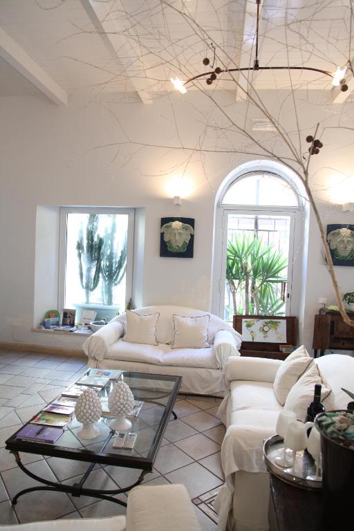 a living room with two couches and a table at B&B Casa Ruffino in Balestrate