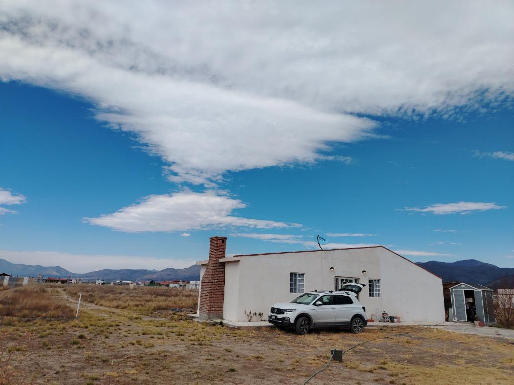 a car parked in front of a white building at Rancho de Solis in Arteaga